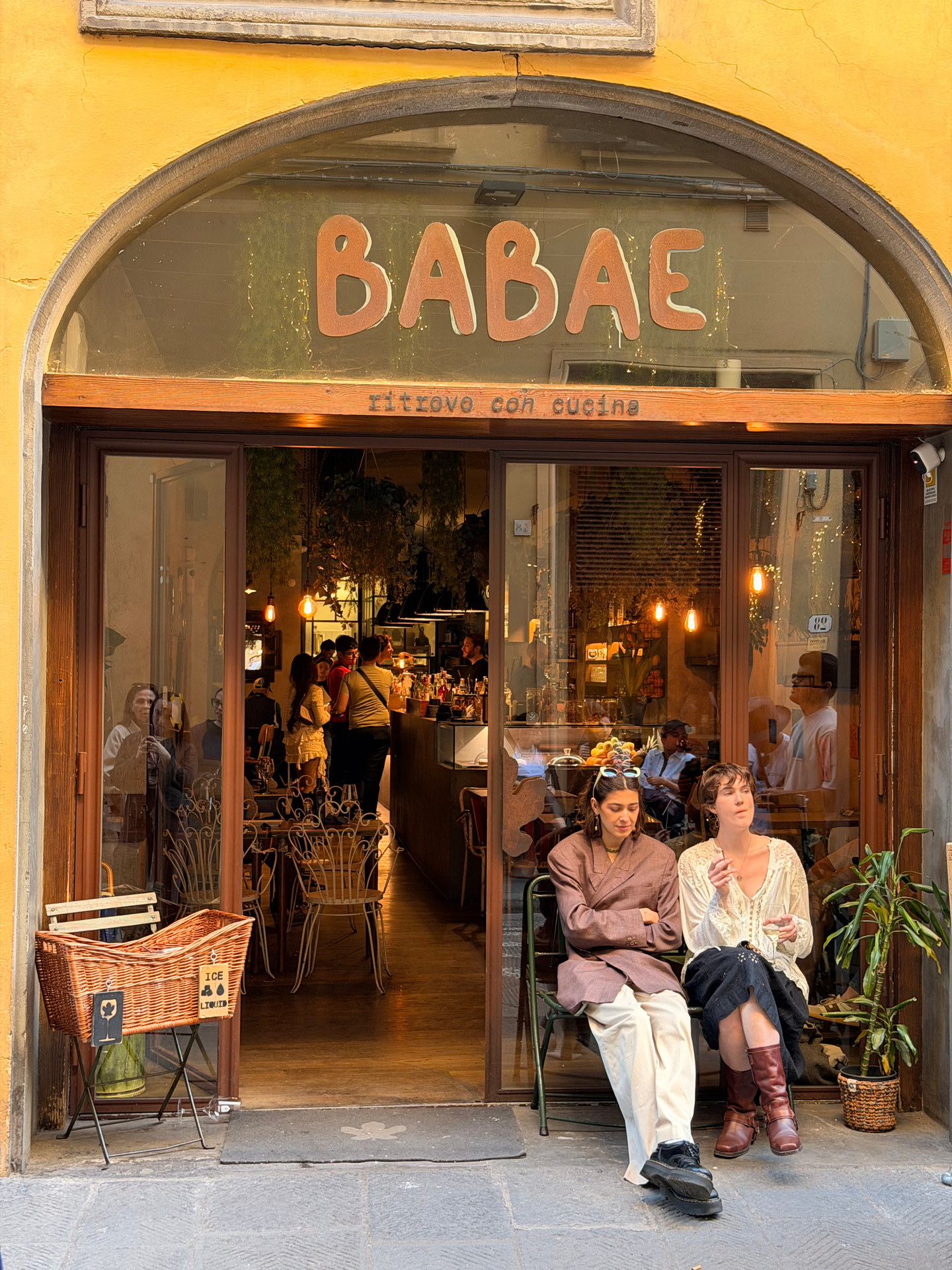 The yellow Babae storefront and outdoor seating in Florence