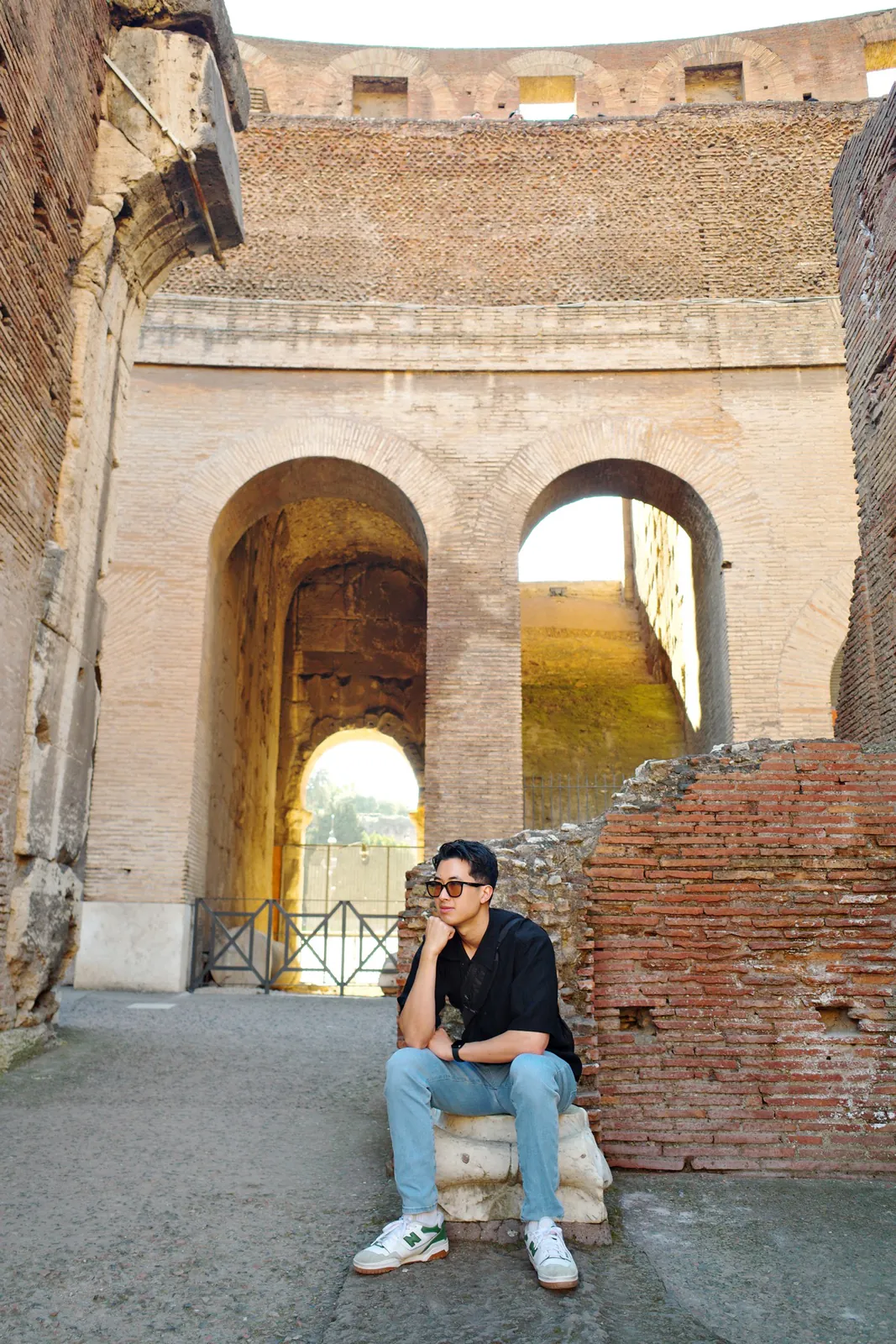 Standing on the reconstructed arena floor inside the Colosseum in Rome