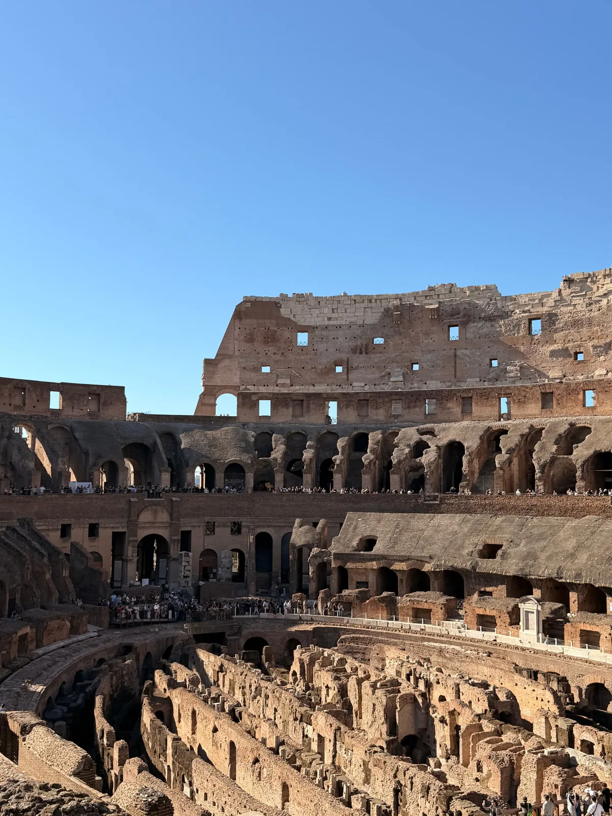 Tiered brick arches and seating levels inside the Colosseum in Rome