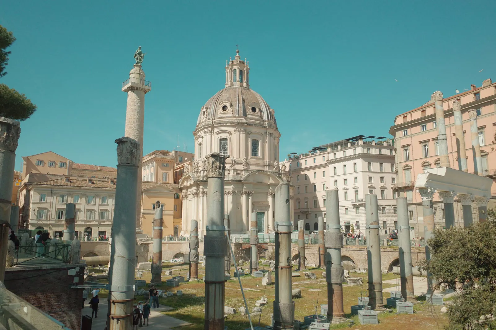 Roman Forum columns with Trajan's Column and a domed church beyond
