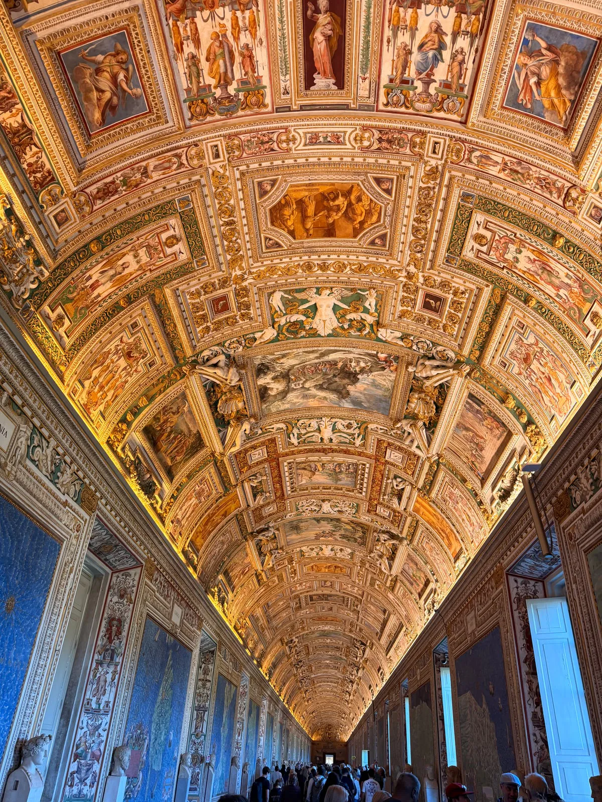 Long decorated gallery with painted ceiling inside the Vatican Museums