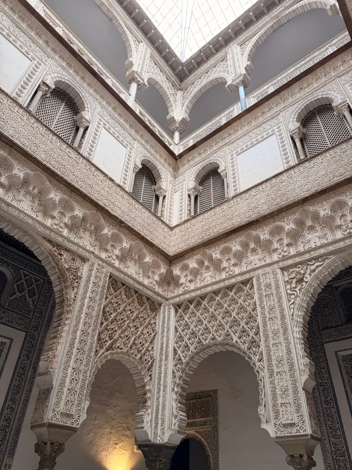 Detailed plasterwork courtyard inside the Royal Alcázar of Seville