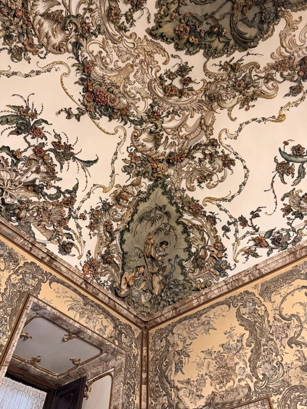 Ornate floral and gilded ceiling detail inside the Royal Palace of Madrid