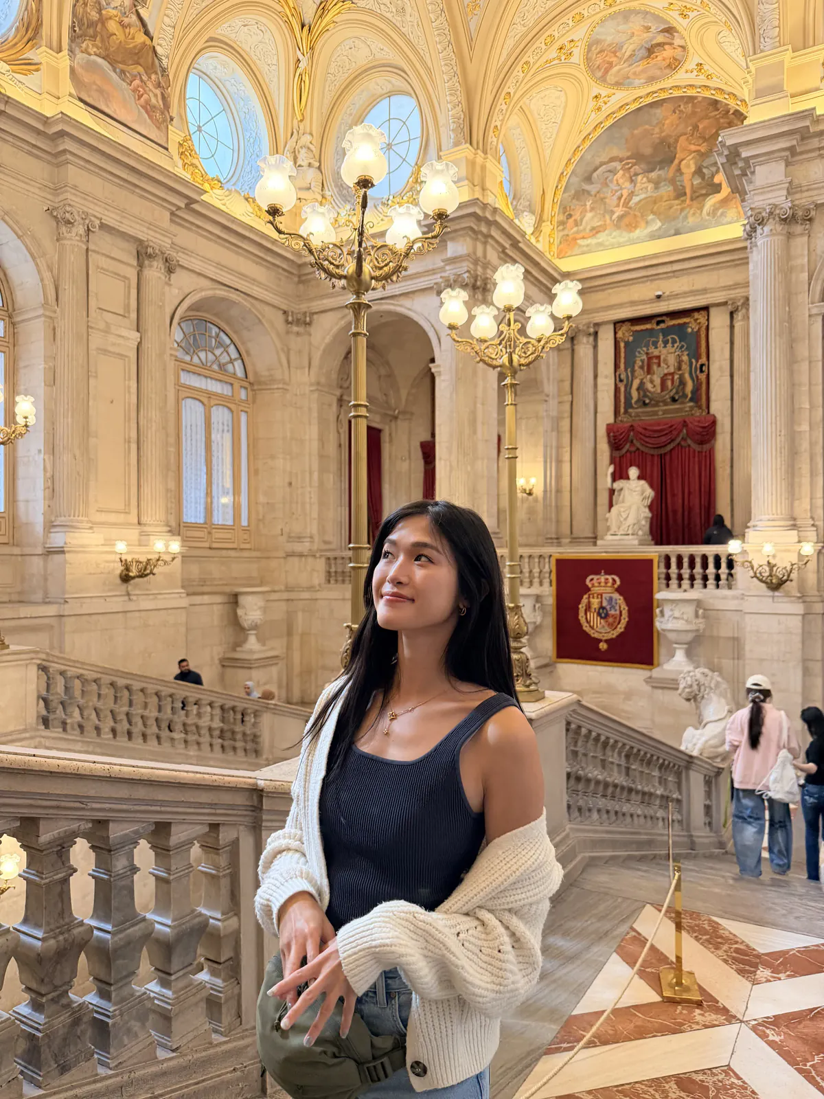 Standing on the Grand Staircase of the Royal Palace of Madrid beneath its painted ceiling