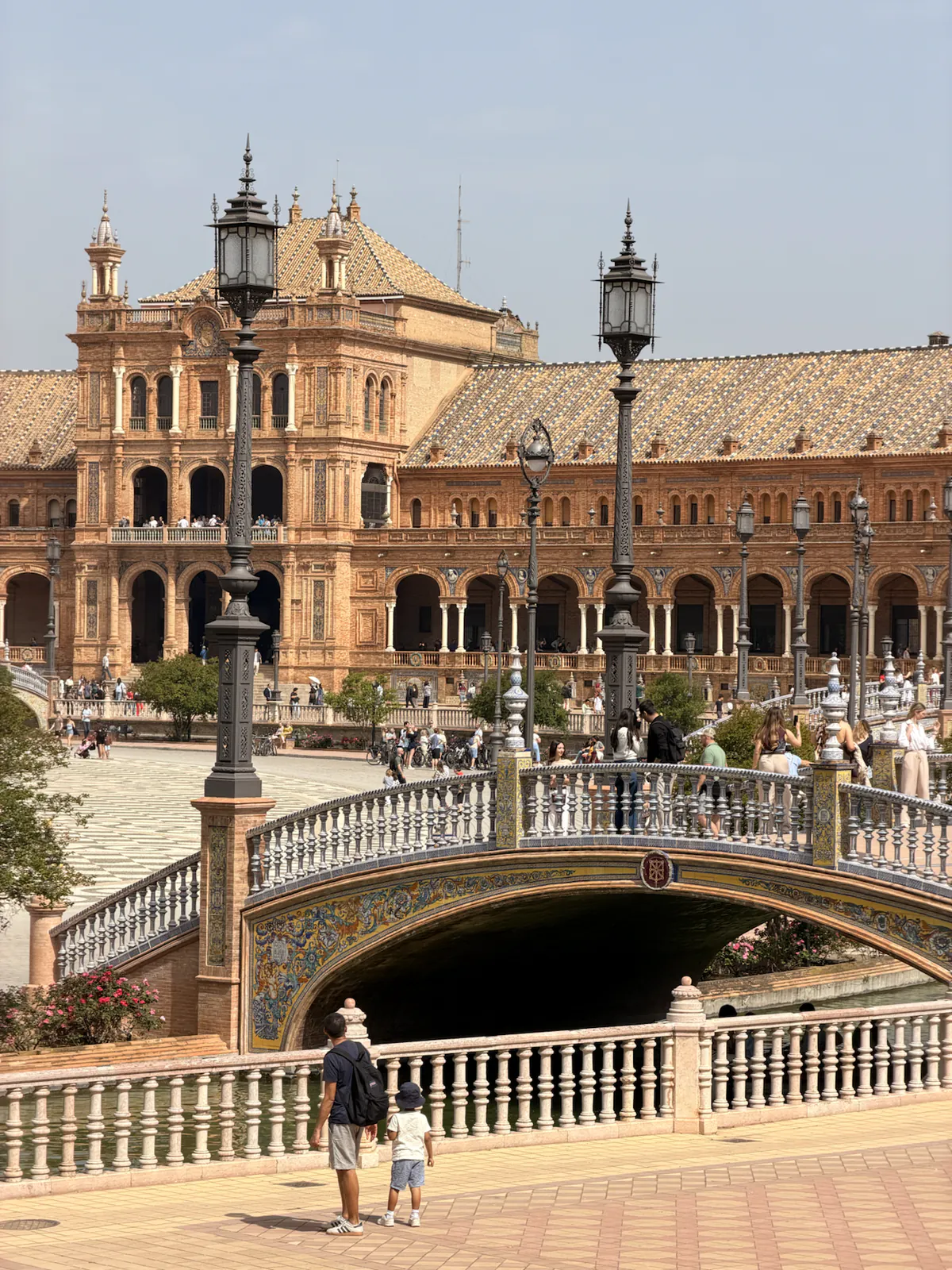 Wide view of a tiled bridge crossing the canal at Plaza de España in Seville