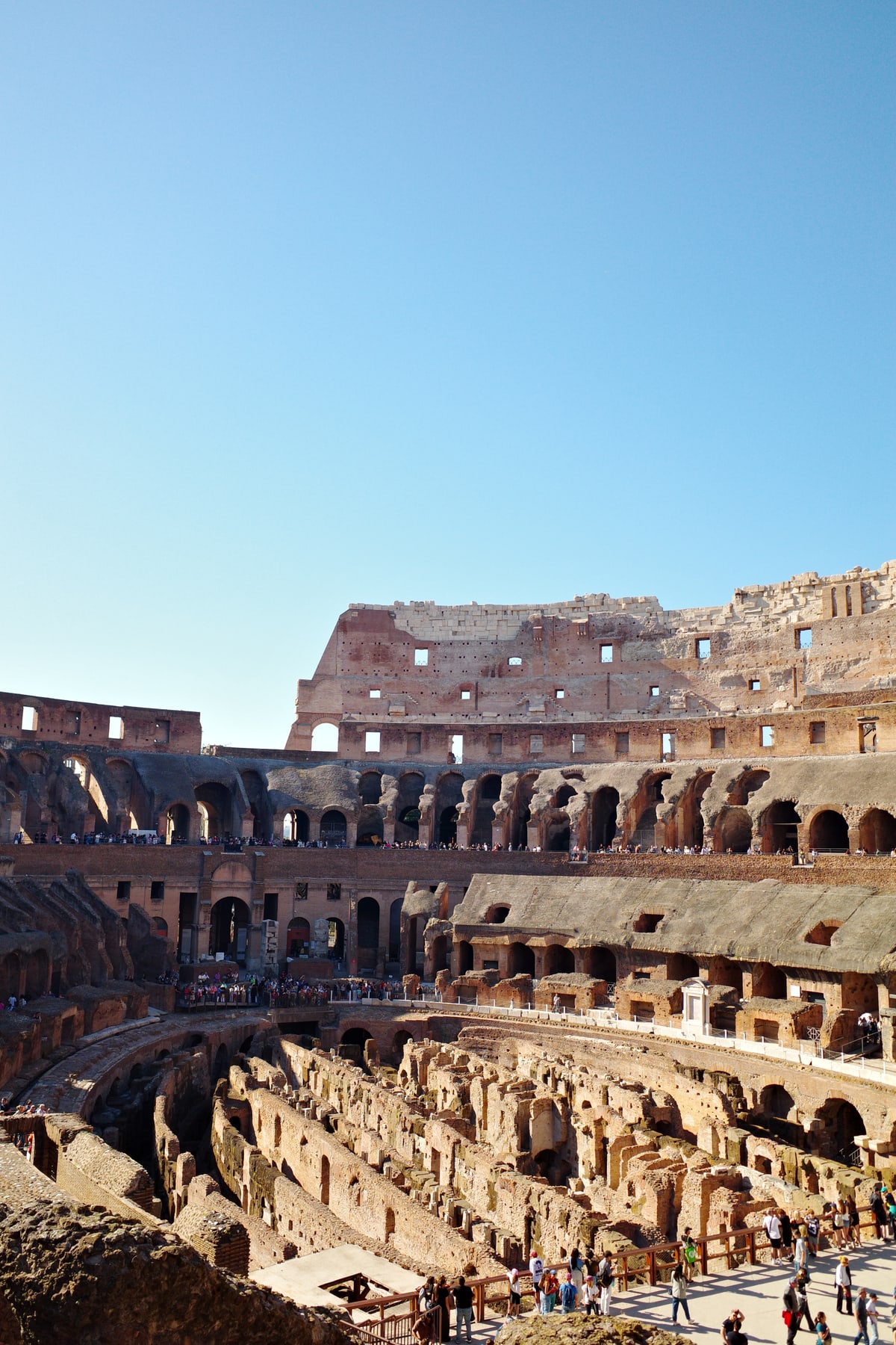 Wide interior view across the Colosseum seating levels and hypogeum