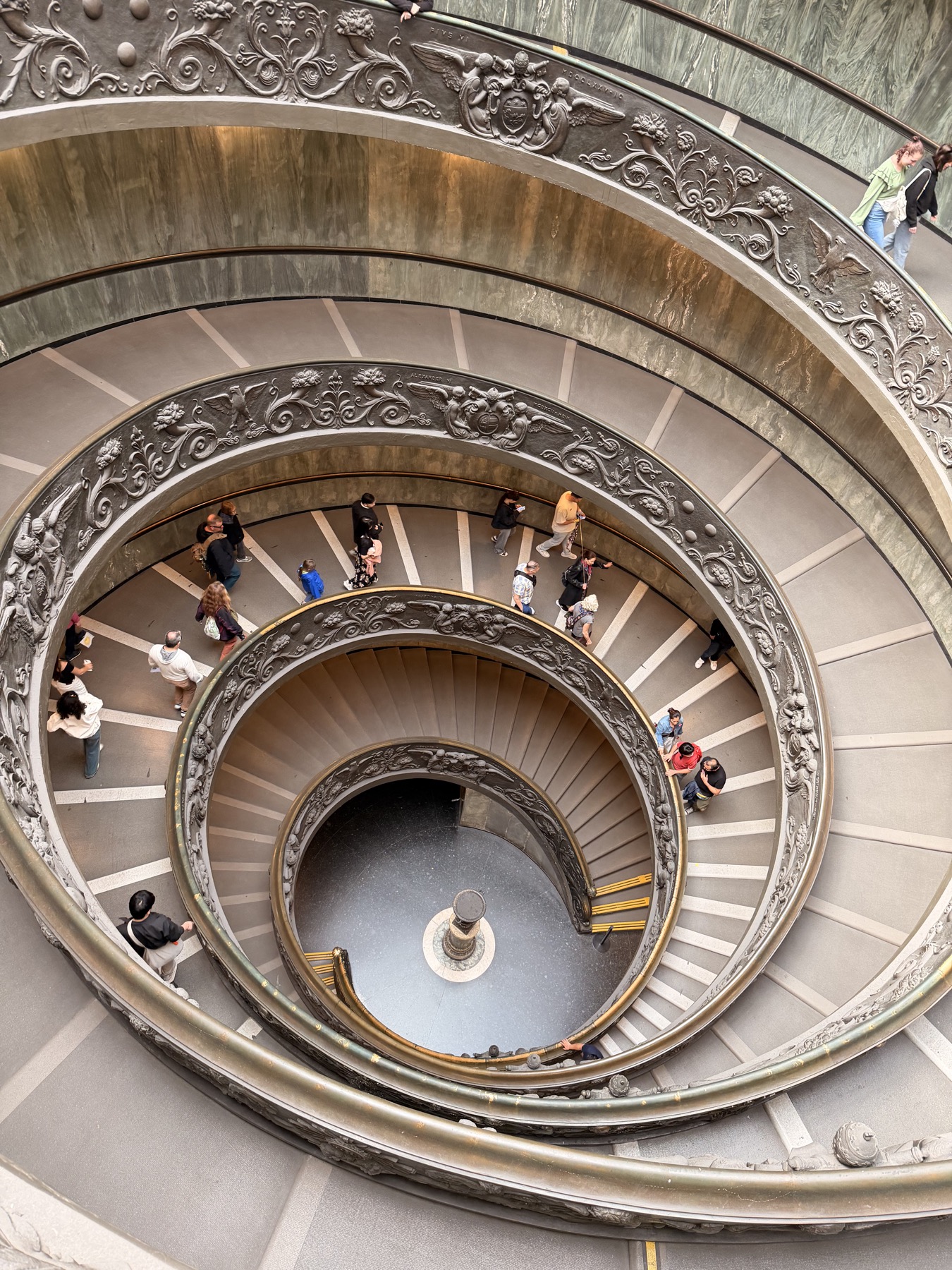 A decorated Vatican Museums gallery with ornate ceiling details
