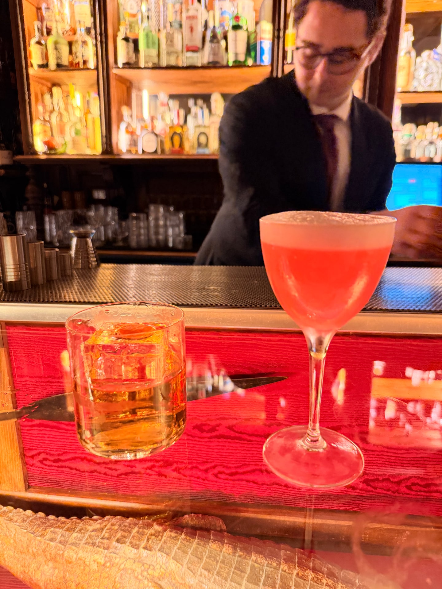 Three cocktails served across the bar at Wisdomless Club in Rome