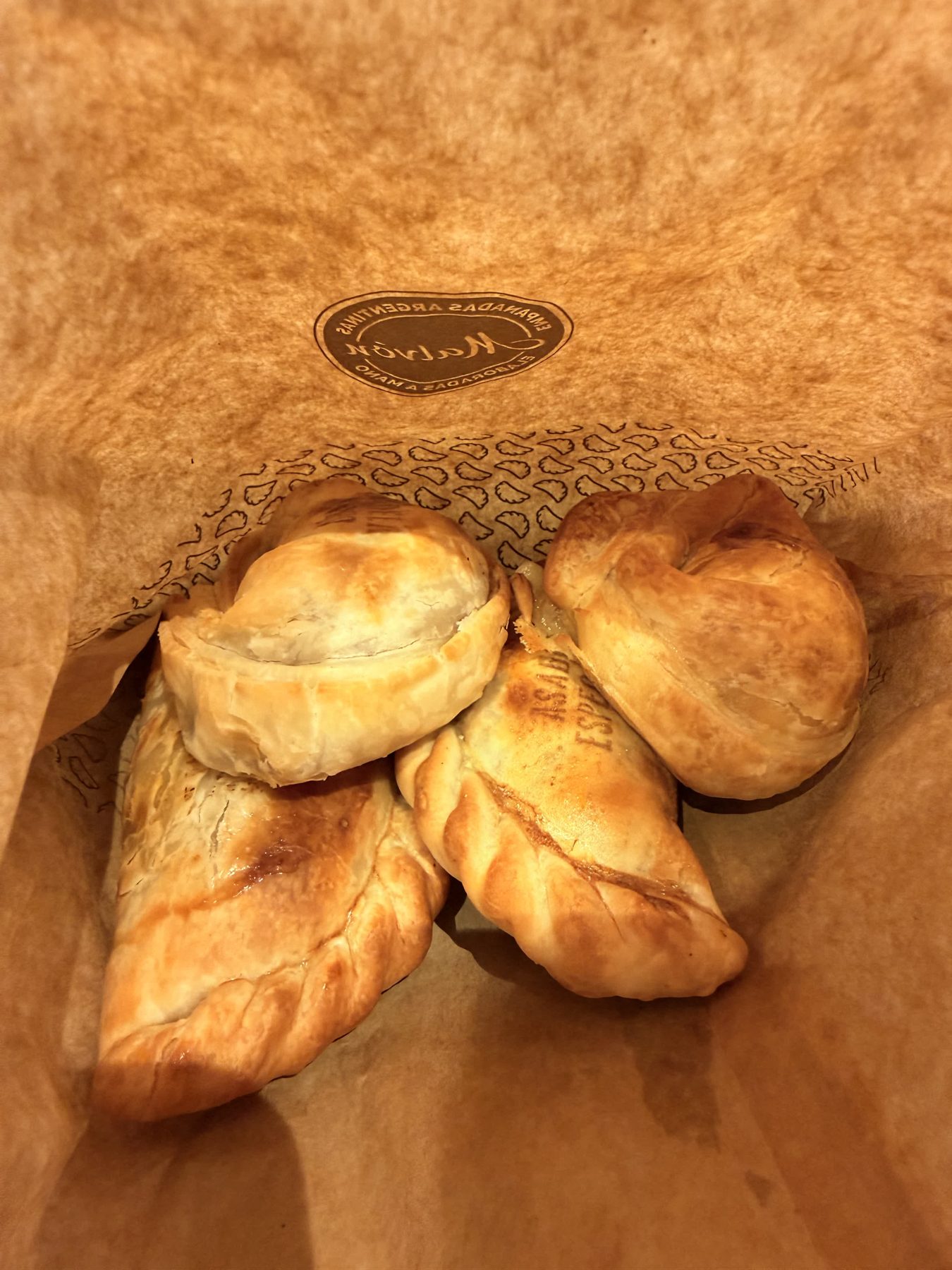 Empanadas inside a takeaway bag from Empanadas Malvón in Seville