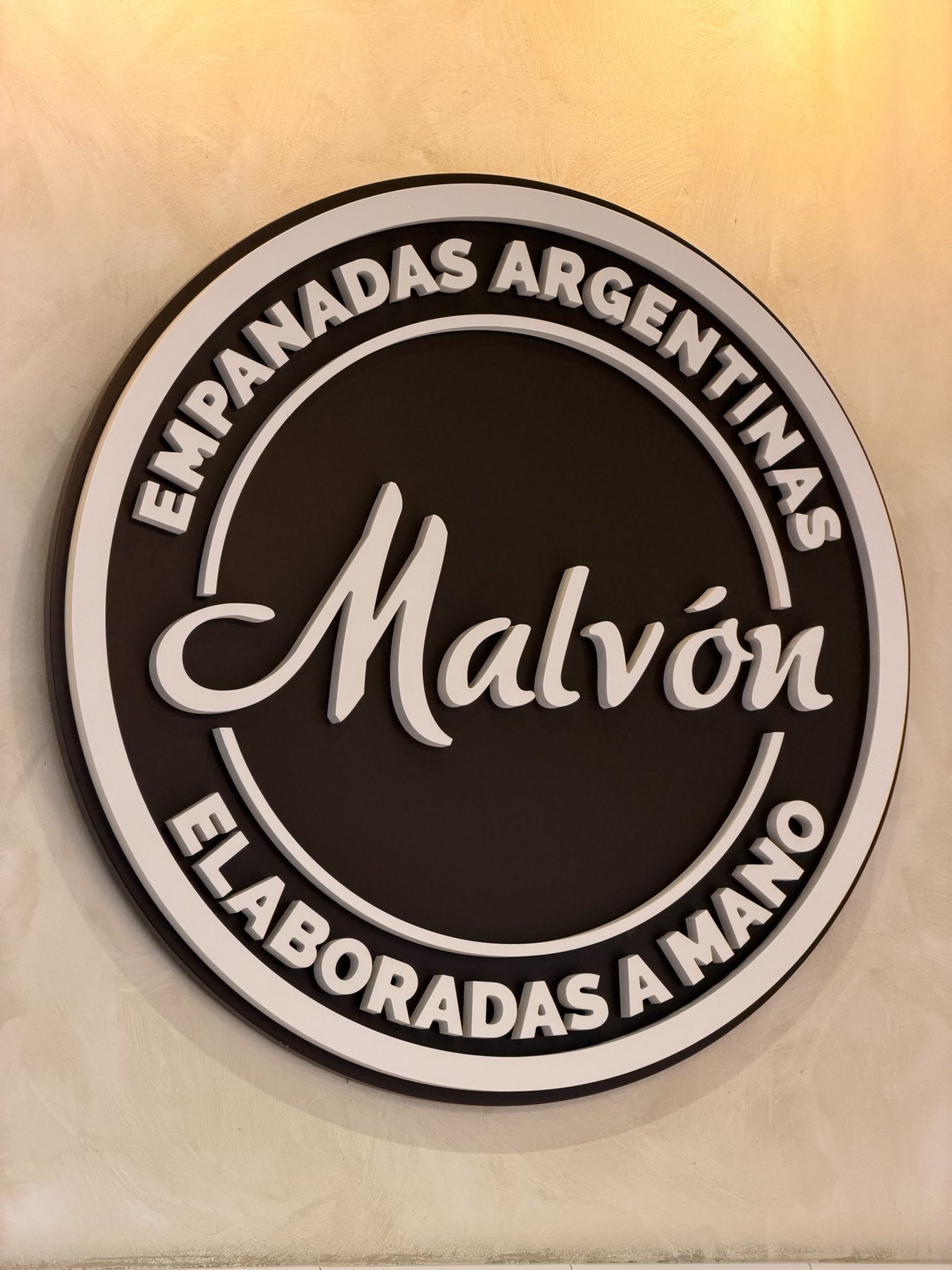 The Empanadas Malvón logo sign in Seville