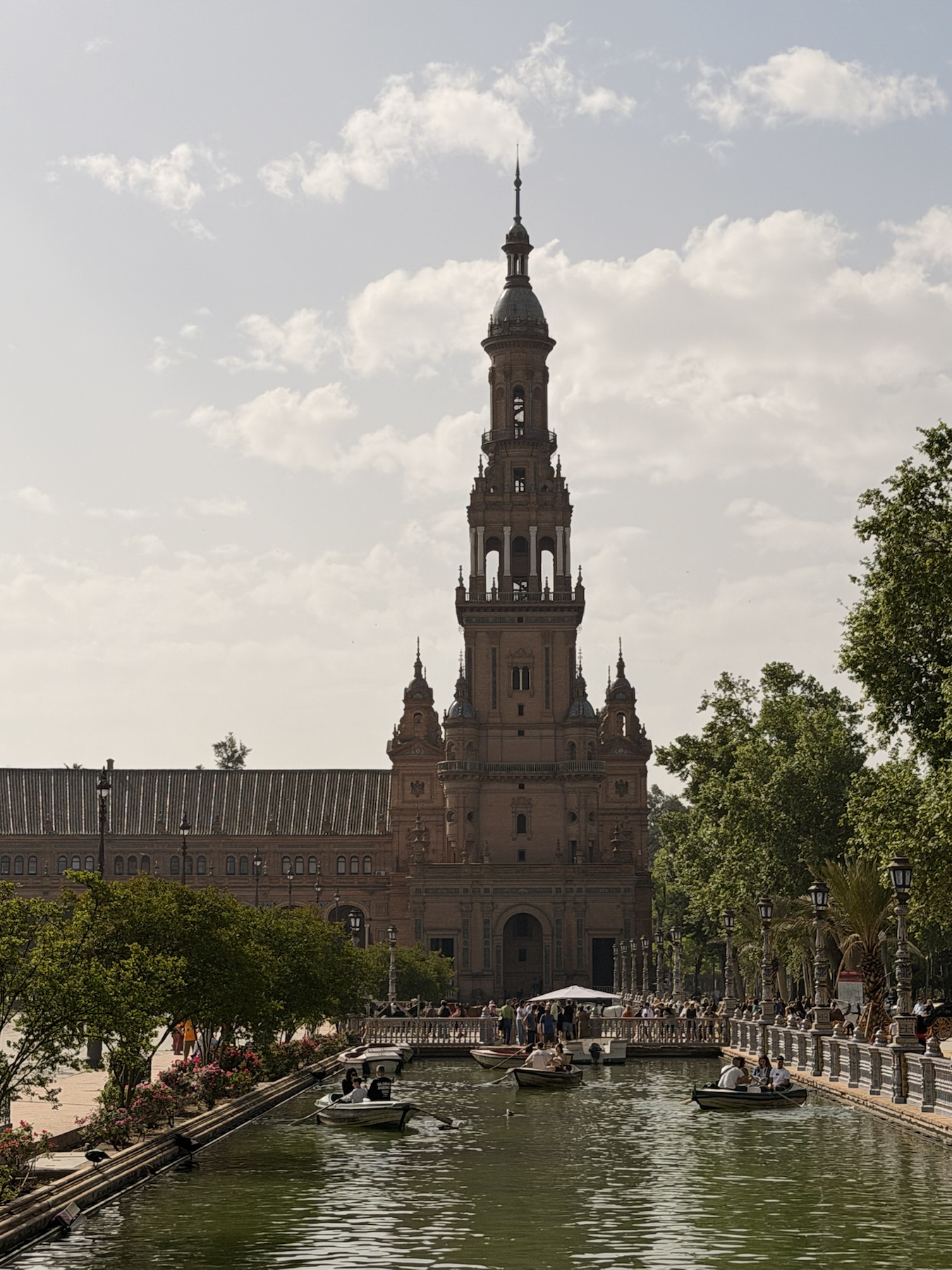 Rowboats on the canal in front of the Plaza de España tower in Seville