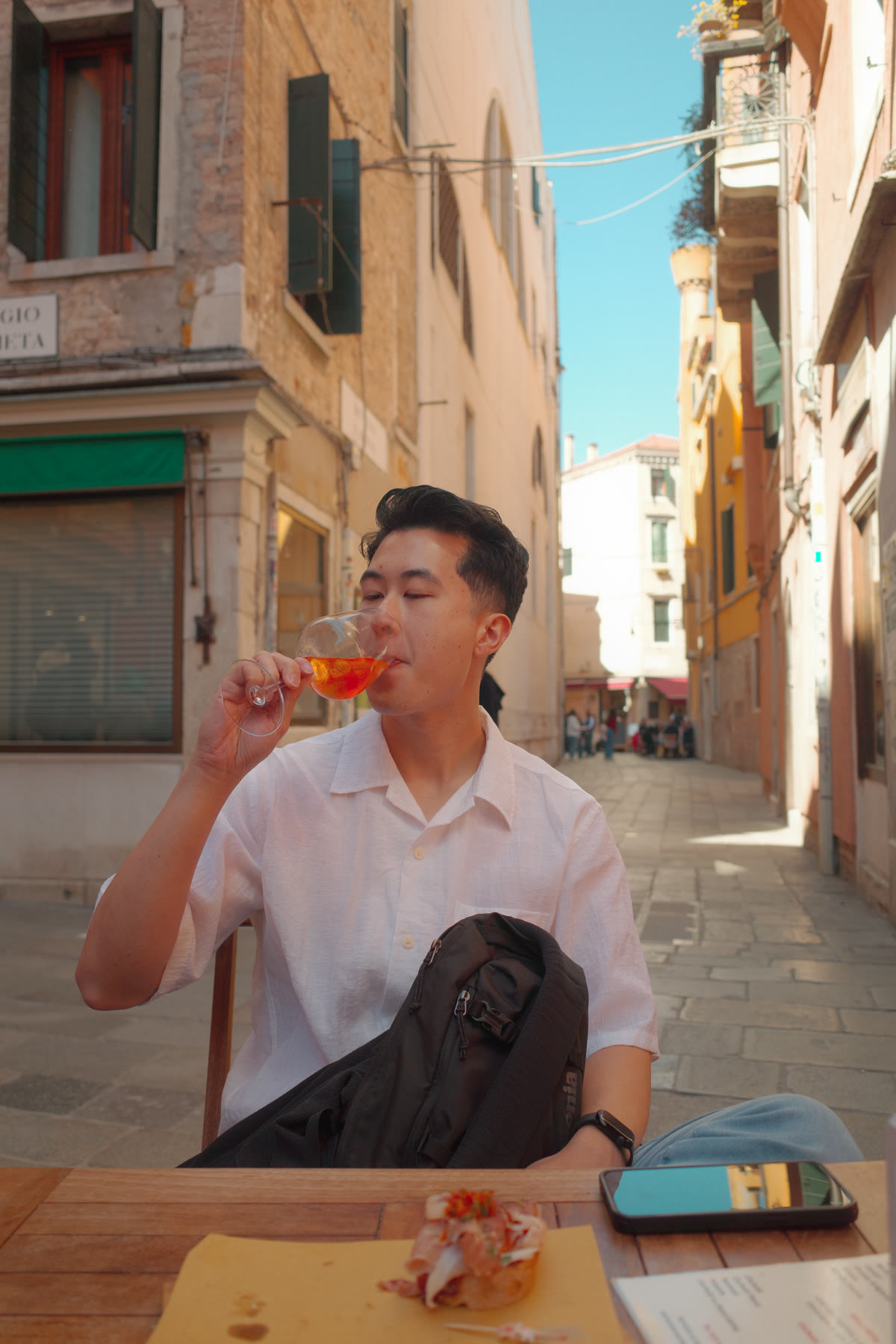 Drinking an Aperol spritz outside Osteria Dai Zemei in Venice