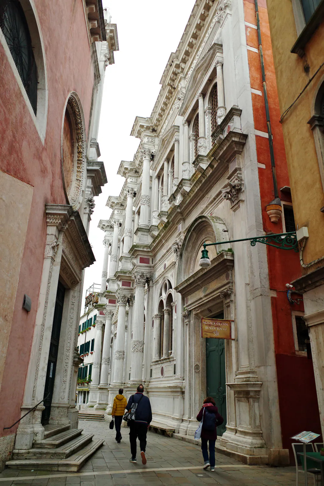 Ornate white stone facade along a quiet Venice alleyway