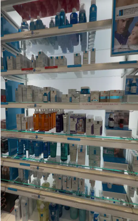 Shelves of La Roche-Posay skincare products inside Farmacia Senato in Rome
